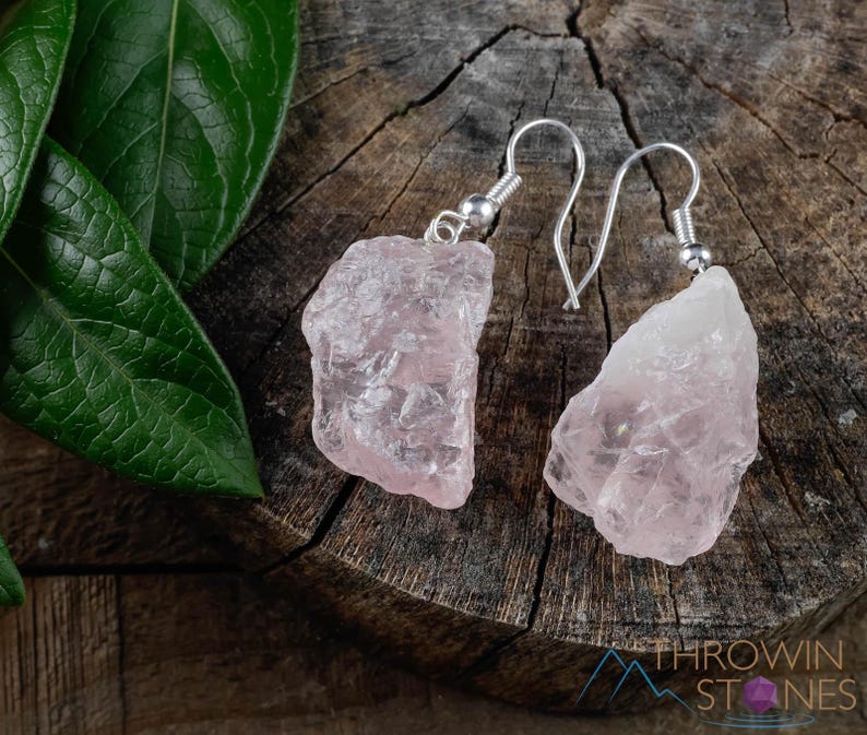 These pale pink Rose Quartz crystal jewelry sets are raw crystal chunk pendants strung on a silver chain, with matching earrings on silver ear hooks.  
Crystals are nature-made therefore each one is unique in appearance.