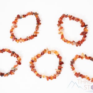 Carnelian chip bracelet. These tumbled chips range in color from orange to red, are drilled and strung on an elastic cord, and create an endless bracelet.
