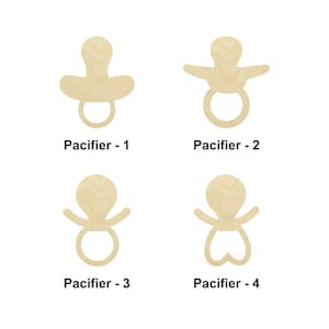 May include: Four wooden pacifier shapes, each with a different design. The pacifiers are all made of natural wood and have a light brown color. The first pacifier has a simple round shape, the second has a more elaborate design with a ring around the center, the third has a simple oval shape, and the fourth has a heart-shaped design.