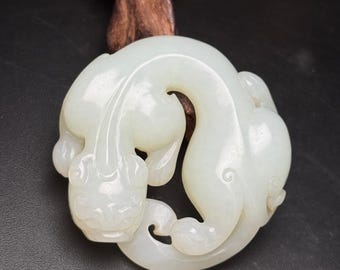 Exquisite hand-carved dragon pendant made of Chinese white jade.