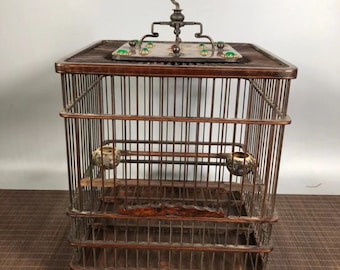 The bird cage in China is handmade and inlaid with gems