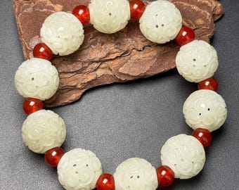 Exquisite Ruyi-patterned bracelet made of pure Chinese white jade, hand-carved.