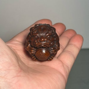 Exquisite and rare hand-carved Chinese boxwood sculpture of Pixiu holding a ball.