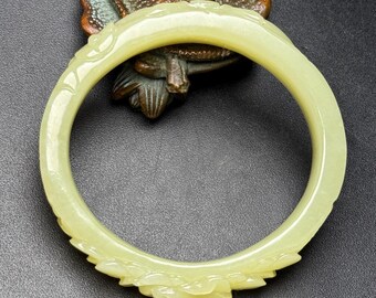 Exquisite flower patterned bracelet carved purely by hand from Chinese white jade