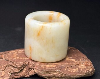 Exquisite hand-carved Chinese white jade thumb ring with inlaid patterns.
