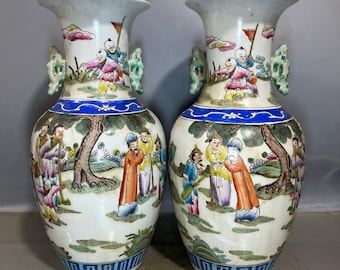 A pair of exquisitely hand-painted famille rose vases with figures and scenes from Chinese antique stories.