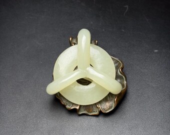 Exquisite three-ring pendant carved entirely by hand from Chinese white jade.