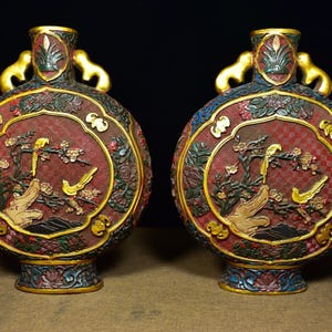 A pair of exquisite and rare Chinese antique hand-carved red lacquerware vases with flower and bird patterns
