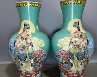 A pair of exquisitely hand-painted Chinese antique Guanyin vases with open windows.
