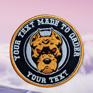 May include: A black and white embroidered patch with a yellow and brown pit bull dog head in the centre. The patch has a white circle around the dog head with the text "YOUR TEXT MADE TO ORDER YOUR TEXT" in white on a black background.