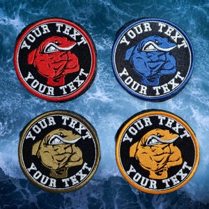 May include: Four embroidered patches featuring a cartoon bulldog wearing a sailor hat. Each patch has a different coloured background: red, blue, gold, and orange. The text "YOUR TEXT" is embroidered around the edge of each patch.