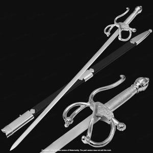 May include: A silver rapier sword with a decorative handle and a black sheath. The sword has a long, slender blade and a complex hilt design. The sheath is black with silver accents.