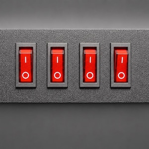 May include: A rectangular black textured control panel featuring four vertical red rocker switches. Each switch is marked with a white vertical line symbol at the top and a white circle symbol at the bottom, indicating on and off positions.