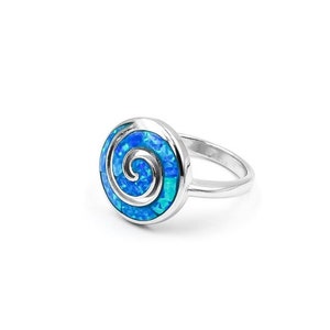 May include: A silver ring with a blue opal stone set in a spiral design.