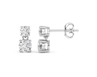 May include: A pair of silver dangle earrings with two round clear stones.