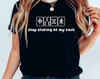 May include: A black t-shirt with a white graphic of mahjong tiles and the text "stop staring at my rack".