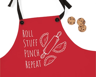 May include: Red kitchen apron with white text that reads "Roll Stuff Pinch Repeat" and a drawing of a rolling pin and three pastries.