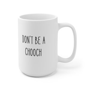 May include: White ceramic coffee mug with black text that reads "DON'T BE A CHOOCH".