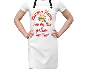 May include: White apron with a red and yellow design that says "Making Pierogi. Pass the flour or get outta my way!"