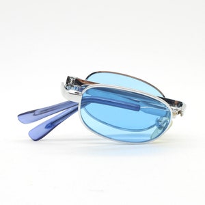 90s micro foldable oval sunglasses. Sky blue lenses in a small silver folding compact frame. Folder. Rave 2000s. Y2K. NOS