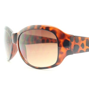 Y2k vintage wrap around bug eye sunglasses. Curved tortoise gloss frame with gradient Havana brown lenses. 2000's NOS