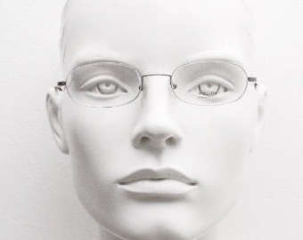 Police 90s vintage oval half rim eye glasses made in Italy. Minimal lightweight optical frame in gunmetal grey. Prescription RX Spectacles