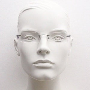 Police 90s vintage rectangular frameless eye glasses made in Italy. Minimal low profile optical frame with black satin metal trim. RX