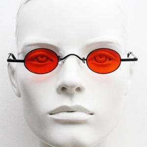 90s vintage small oval sunglasses. Imposing minimal black gloss metal victorian antique style frame with bright red lenses. Steampunk. NOS