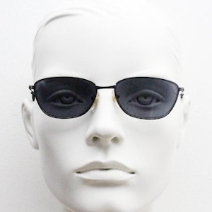 90s vintage angular pointed sunglasses. Minimal grey chrome metal frame with embossed patterned arms. Subtle cat eye. NOS