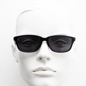 Vintage 90s slim rectangular modified wayfarer design sunglasses made in Italy. All black gloss low profile acetate frame. Unused NOS