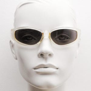 90s vintage sports shield sunglasses. Transparent yellow aerodynamic curved wraparound frame with contrasting black lenses. 2000&#39;s rave