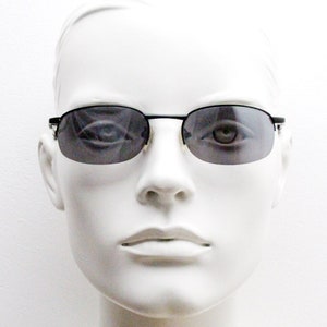 90s vintage small oval black sunglasses. Satin finish half frame with grey lenses and slight mirror glaze. 2000&#39;s. Y2K. Unused NOS