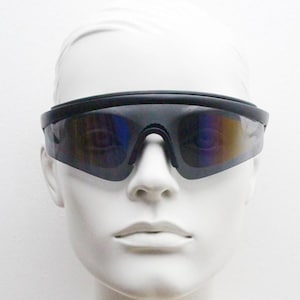 May include: Black sport sunglasses with a wraparound design. The lenses have a mirrored finish with hints of blue and yellow. The sunglasses are set against a white background.