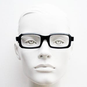 May include: A set of three ceramic mugs with a speckled, matte finish. The mugs are in shades of cream, light gray, and dark gray. Each mug has a simple, minimalist design, perfect for coffee or tea.