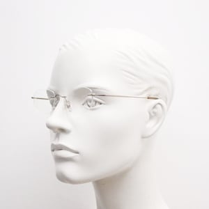 90s vintage angular oval frameless eye glasses. Minimal lightweight titanium optical frame. Flexible prescription RX spectacles