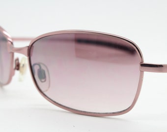 Y2K vintage curved sunglasses. Pink chrome metal frame with matching flared rectangular lenses. Unused 2000s NOS