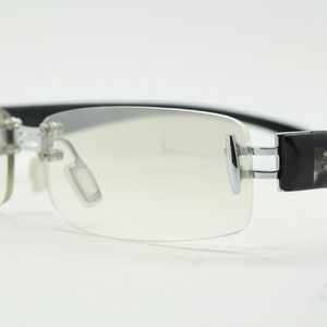 Y2K vintage frameless sunglasses. Silver chrome trim with patterned arms and extra light tone graduated curved mirror lenses. 2000&#39;s. 90s