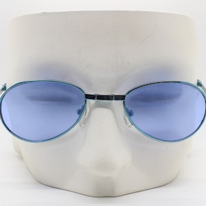 Y2K micro foldable oval sunglasses. Sky lenses in a small folding matching coloured compact frame. Folder. Rave 2000s. 90s NOS