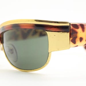 90s vintage visor shield sunglasses. Substantial metal curved wraparound frame with metallic tiger brow and abstract arm patterns. NOS. BNWT