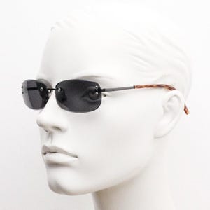 90s vintage minimal frameless sunglasses. Black rectangular lens with gunmetal grey trim and tortoise arms. Simple and effective design. NOS