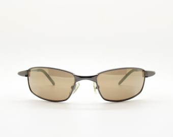 90s vintage curved rectangular sunglasses. Solid metal low profile frame in brown chrome with slightly mirrored lenses. 2000's. Y2K NOS