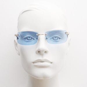 Y2K vintage frameless sky blue sunglasses. Minimalistic rectangular lenses with gold bridge and arms. 2000s club kids. 00&#39;s. 90s Rave