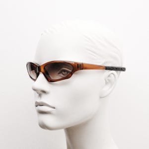 90s vintage sports shield sunglasses. All brown gloss aerodynamic wraparound with light tone lenses. 2000&#39;s NOS in small size