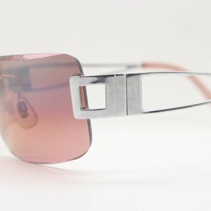 Y2K vintage rectangle frameless visor sunglasses. 2000's chrome trim wrap around with pink curved and bevelled lenses. 00's NOS