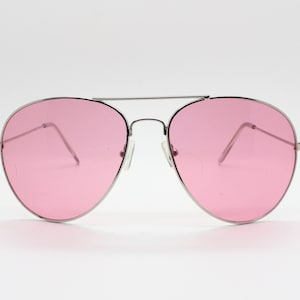 May include: Silver aviator sunglasses with pink lenses.