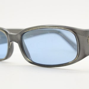 Y2K vintage rectangular shield sunglasses. Purple front, black arms blue lens combo. Visor style wrap around pearlised frame. NOS. 2000s