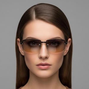 May include: Rimless sunglasses featuring rectangular lenses with a dark brown to light amber gradient tint. The eyewear has a thin dark metal bridge and slender temples, showcasing a clean, streamlined design with visible silver-toned hardware.
