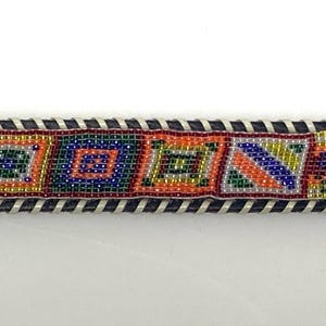 80s vintage thick Leather Native American Indian style belt. Full beaded applique, looped tape edge, embossed pattern and textured buckle