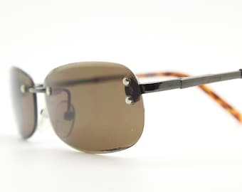 90s vintage minimal frameless sunglasses. Minimal brown rectangular lens with bevelled edges, gunmetal grey trim and tortoise arms. NOS