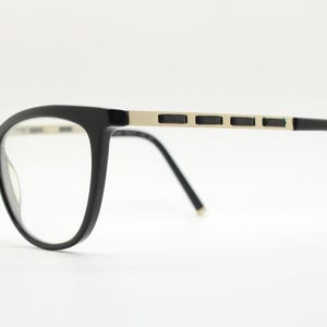 Vintage elegant cat eye glasses by Heritage. Black gloss acetate optical frames with leather lattice arms. Prescription RX cateye spectacles